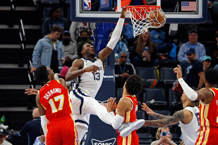 Grizzlies forward Jaren Jackson Jr. dunks against Hawks defenders.